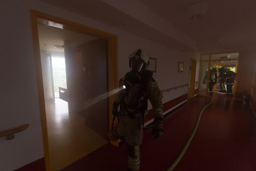 Firefighters in action. Fire department training.
