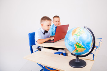 two boys sit at the computer training school