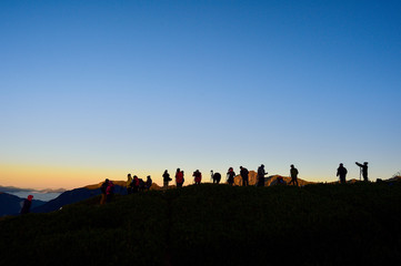 Fototapeta na wymiar Taiwan, Hehuan mountain - October 21th. 2017:silhouette ofphotographer on top of mountain at sunset background 