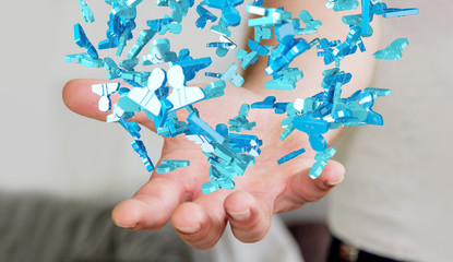 Businessman holding 3D rendering group of blue people