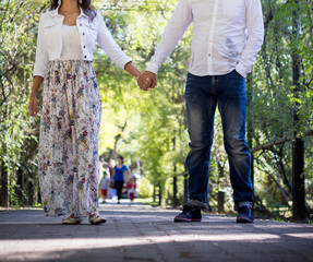Young couple strolling in summer in the park