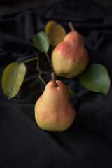 Raw pear on black background