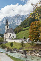 Parish church St. Sebastian with the Ramsauer Ache and the Reiter Alpe in background