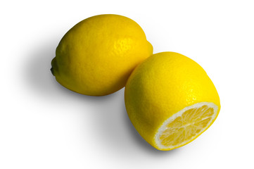 Two lemons, whole and cut on a white background