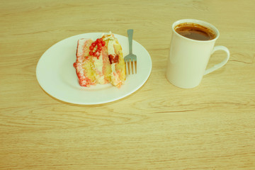 Sliced tasty cake and coffee on table background. Cake with fres