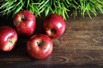 Red fresh apple on a wooden table