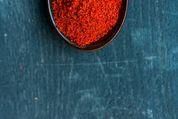 Studio shot of red paprika powder in spoon