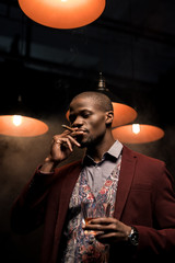 man with whiskey smoking cigar