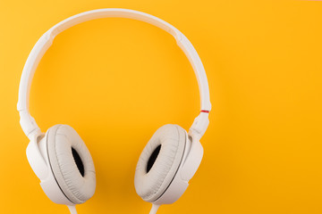 White headphones on a yellow background