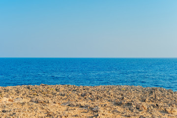 Fototapeta na wymiar View of the blue sea. Dried earth
