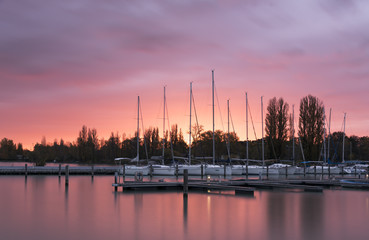 Harbour with white yachts and amazing sunrise on Balaton lake in Hungary