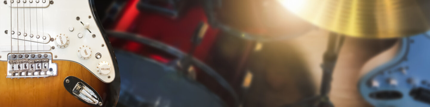 Piano keyboard and guitar musical instrument on stage background.