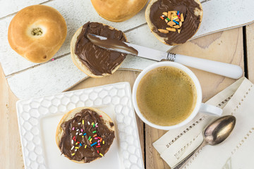 Breakfast with fresh mini bagels with chocolate hazelnut spread.
