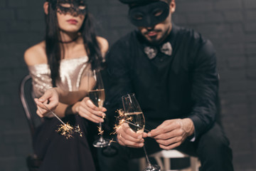 multicultural couple in christmas masks with sparkles