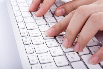 Woman working at home office hand on keyboard on white background