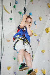 Child climbing on a high wall