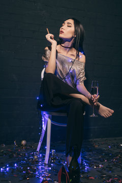 asian woman with cigar and champagne