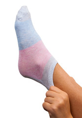 woman dresses a sock on a foot. isolated on white