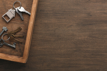 Many different keys on wooden tray
