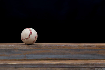 Baseball on a old rustic wooden desk with partial blur background