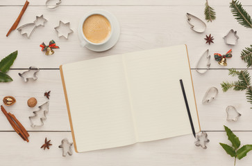 Notepad, coffee and cookie cutters top view, copy space