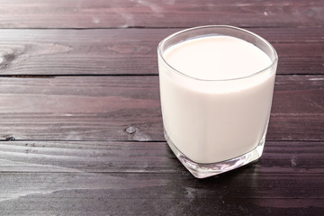 Fresh milk on wooden background