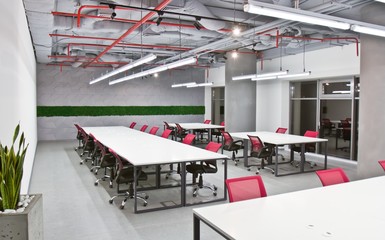 Conference room interior with empty chairs and a projector screen