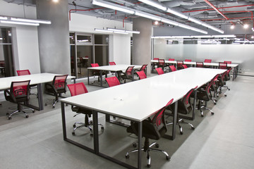 Conference room interior with empty chairs and a projector screen