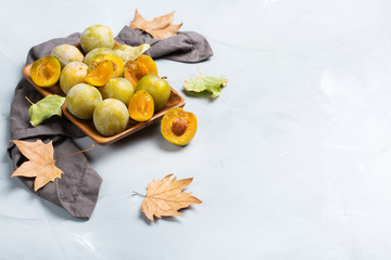 Harvest fall autumn concept. Ripe juicy yellow plums