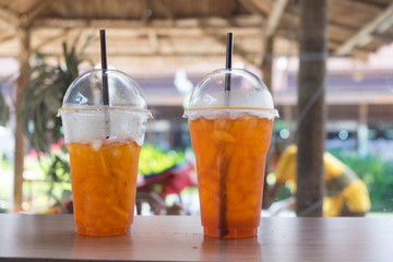 Cold iced tea with lemon and straw