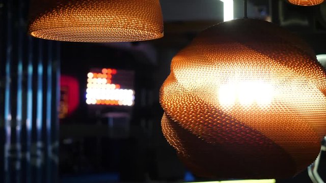 Warm lighting coming out from beautiful lamps while taking a hot cup of coffee in a trendy cafe with nice environment