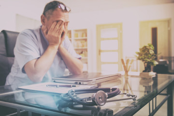 Overworked doctor in his office