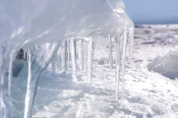 Ice with transparent icicles. Winter time at Lake Baikal
