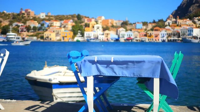 wooden table and chairs prepared for clients by the sea coast