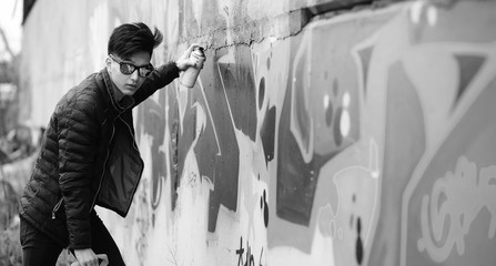 Black White photo of Asian young man outdoors posing