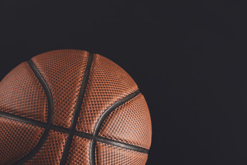 Old basketball ball on black background copy space