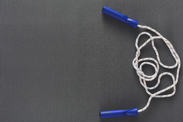 Top view of jump rope on black background