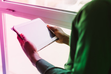 Close up on the hand on a businessman holding tablet - technology, business, working concept
