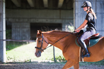Portrait of young woman riding her horse