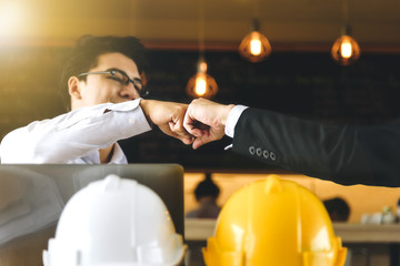 Engineer and businessman handshake,fist collide agreement in negotiations in Business conference...