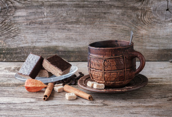 coffee in a ceramic mug and chocolate wafer cake