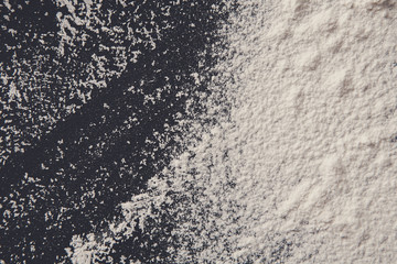 White flour on black background, abstract texture