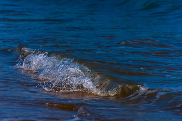 close up of the sea water affecting the sand on the beach, sea waves calmly flowing sand, relaxing...