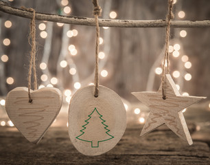 Wooden vintage Christmas decoration over bohek lights background