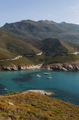 Corsica, 28/08/2017: barche nell'acqua cristallina dell'Anse d'Aliso o Plage d'Alisu, una delle spiagge più remote del versante occidentale di Capo Corso