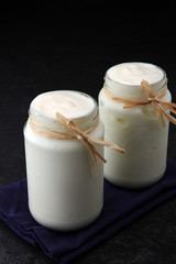 greek yogurt in glass jar. natural creamy yoghurt.