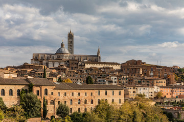 Fototapeta na wymiar Beautiful view of Dome and campanile of Siena Cathedral, Duomo di Siena, and Old Town of medieval city of Siena in the sunny day. Tuscany, Italy.