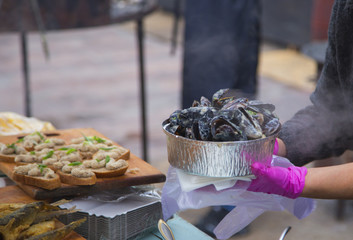 A pot of stewed mussels at a street market