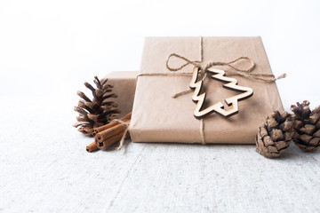 New Year's gifts next to the pine cone and cinnamon Christmas presents