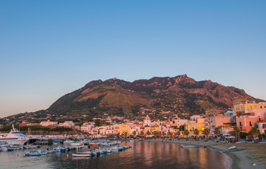 Fototapeta premium Panoramic view of Forio at sunset, Soccorso Church, Ischia, Phlegrean Islands, Tyrrhenian Sea, Italy, South Europe
